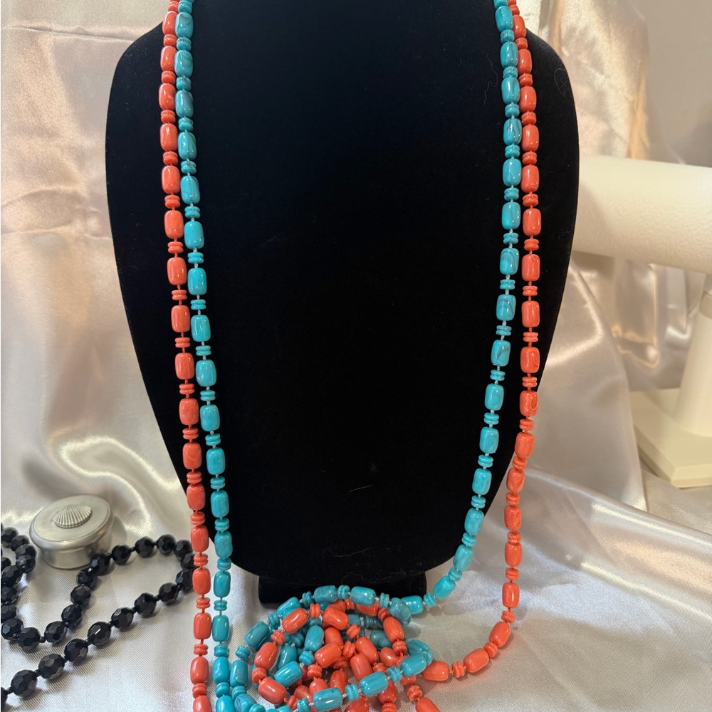 Turquoise and coral color beads are used to create this set of 2 necklaces.